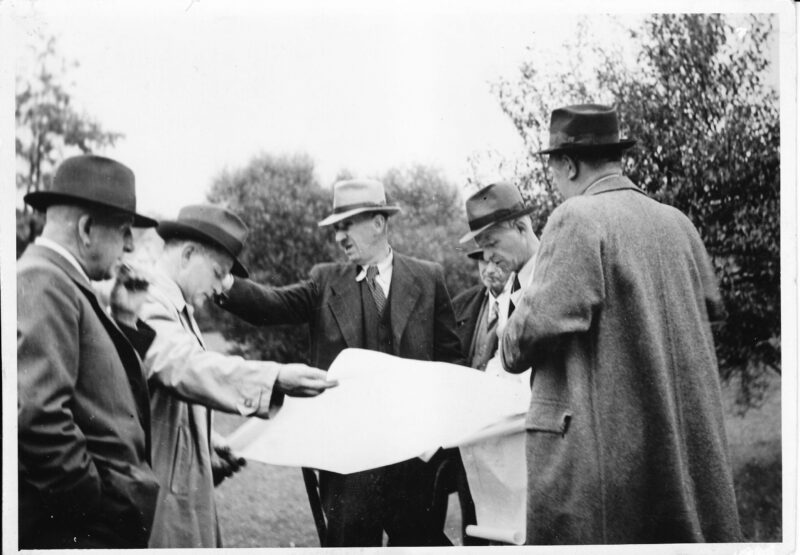nad plány koupaliště Holá Hostýn, stavby vedoucí Václav Klučina, zády stojí asi stavitel Votava, fotografie Brokešovi (rok asi 1940)